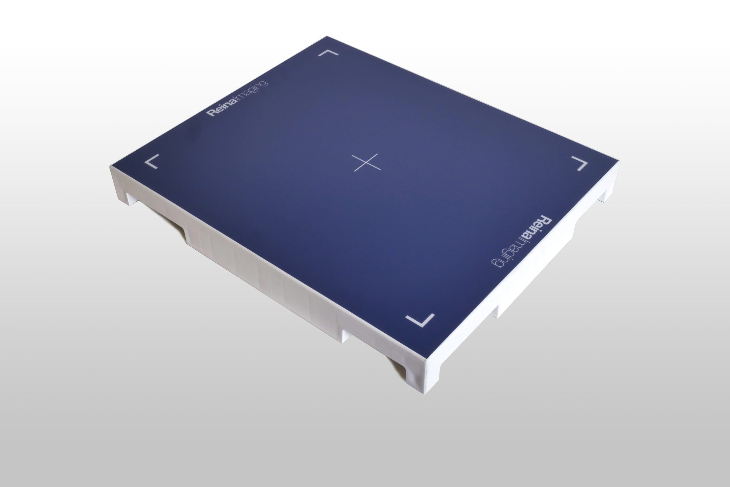 Flat rectangular panel with a dark blue surface, white edges, and corner markers, featuring a centered crosshair.