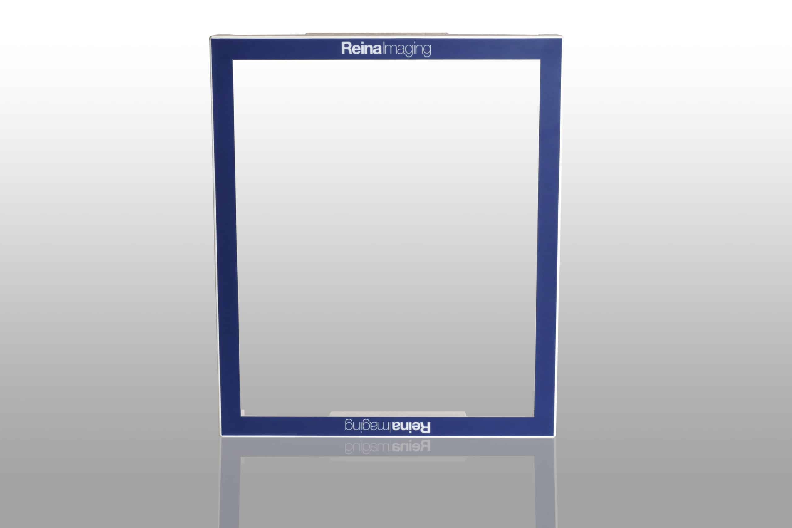 Blue rectangular frame with white inner edges and “Reina Imaging” text at the top and bottom, placed on a reflective surface.