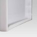 Close-up angled view of the bottom edge of a white frame with a recessed groove and smooth finish.