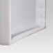 Close-up angled view of the bottom edge of a white frame with a recessed groove and smooth finish.
