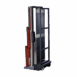 Rear angled view of a mobile X-ray cassette holder with metal frame and wheels.