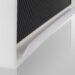Close-up of a white frame corner with an integrated bottom handle attached to a carbon-fiber imaging panel.