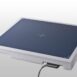 Flat rectangular panel with a dark blue surface, white edges, and a centered crosshair, featuring a connected cable.