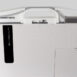 Rear view of a white panel with integrated handle, cable, and connector ports.