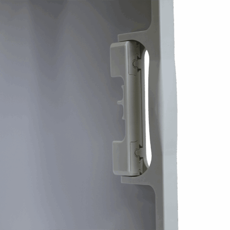 7-CC14_HANDLE_DETAIL Close-up of a white plastic handle mechanism on the edge of a medical equipment panel.