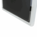 Close-up of a black flat panel detector partially enclosed in a white protective holder