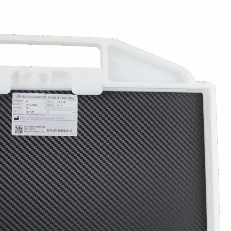 7-PBDR14-HANDLE-BACK-DETAIL Close-up of a carbon-fiber radiographic grid with a white plastic handle and label