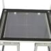 Top view of a white metal frame with a black border and glass panel insert.