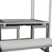 Metal frame structure with a white bench and integrated slots for components