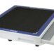 Angled view of a white rectangular panel with a black textured surface, blue border, and a handle cutout on the side