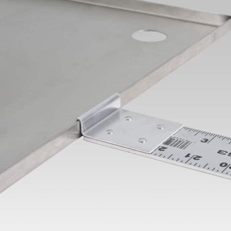 PP-WR-FEATURE Close-up of a metal plate with an attached ruler and mounting bracket.
