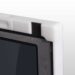 Close-up of a white corner protector with black foam padding on a carbon fiber X-ray grid frame