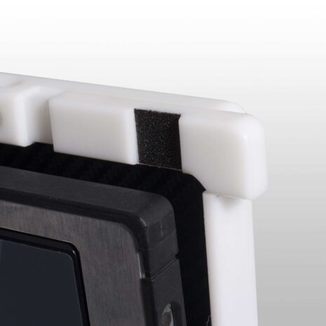 ps14-action1-Copy-scaled Close-up of a white corner protector with black foam padding on a carbon fiber X-ray grid frame