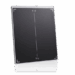 Angled view of a black X-ray grid with white alignment markers, encased in a slim white protective frame