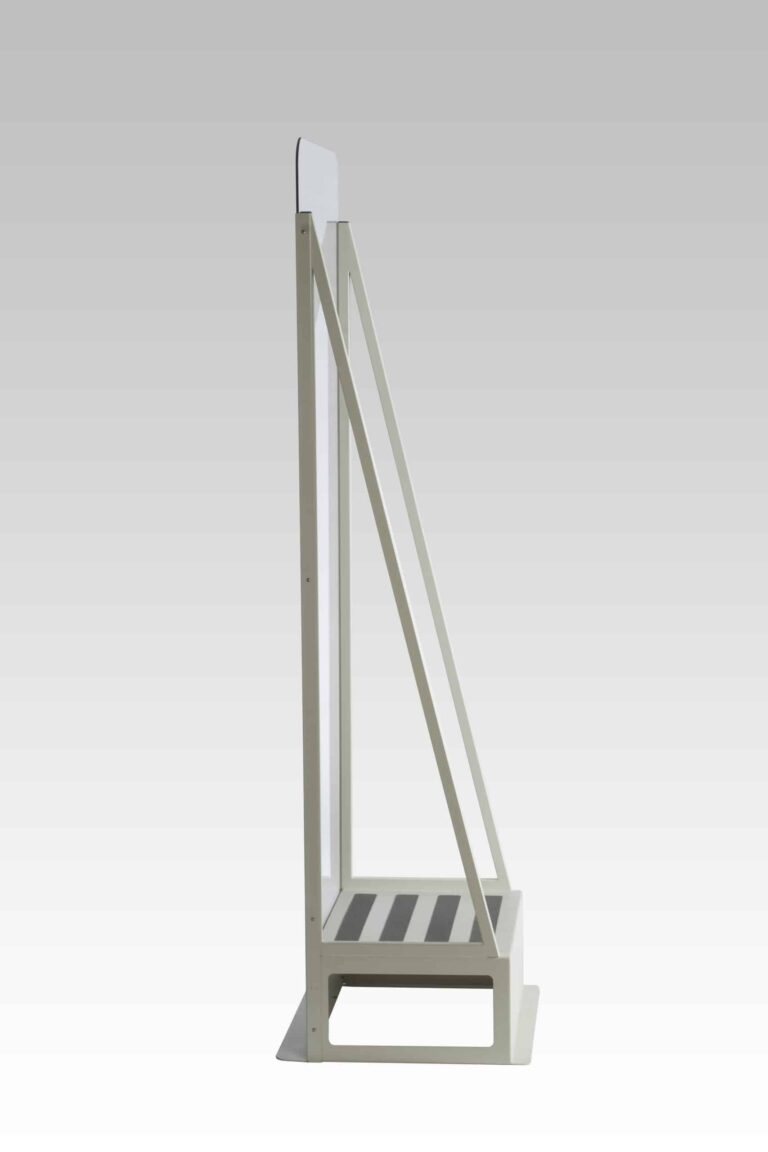Side profile view of protective shield with clear panel and angled support frame on solid base