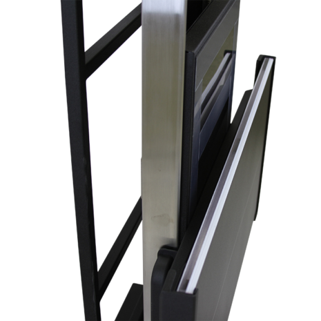 tm80i_detail_grid Angled view of a metallic stand with a black frame and a mounted panel, showing layered components and a slim rectangular support structure.