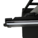 Close-up of a black metal bracket holding a thin white panel, showing layered edges and part of a support frame above.