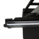Close-up of a black metal bracket holding a thin white panel, showing layered edges and part of a support frame above.