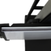 Close-up of a black metal bracket with a mounted glass or acrylic panel edge.