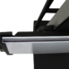 Close-up of a black metal bracket with a mounted glass or acrylic panel edge.